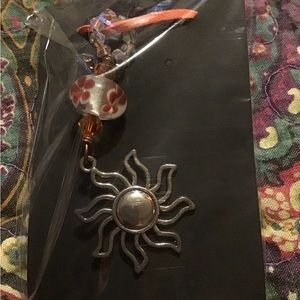 Crystal stone with sun pendant
